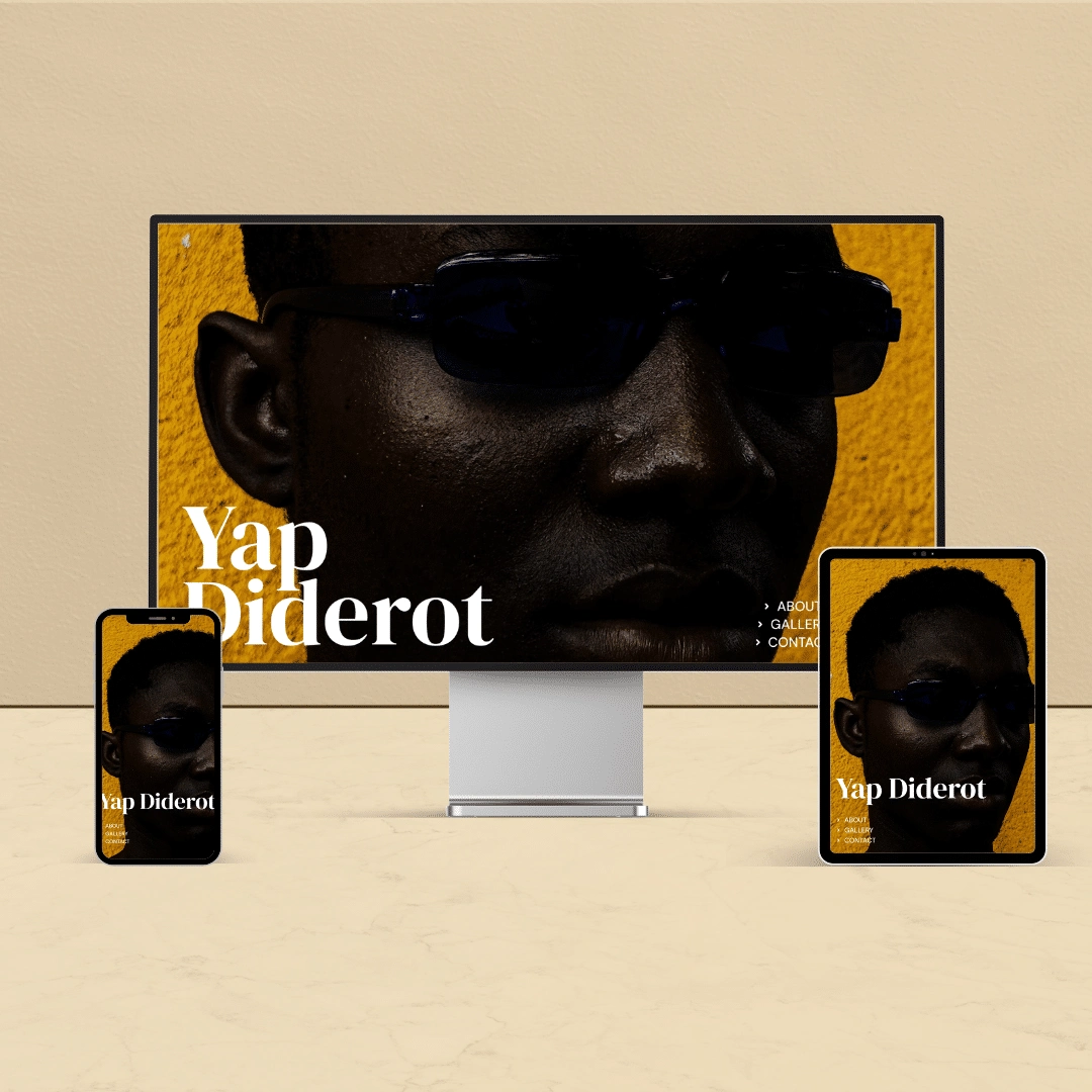 This shows an example of a website that advertises Photographer, as shown on a desktop, laptop and tablet.